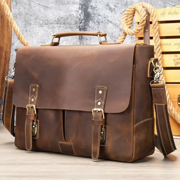 1 (1) Vintage brown leather briefcase on rustic wooden background, studio shot