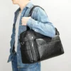 1 (10) Man carrying black leather duffle bag, casual denim style