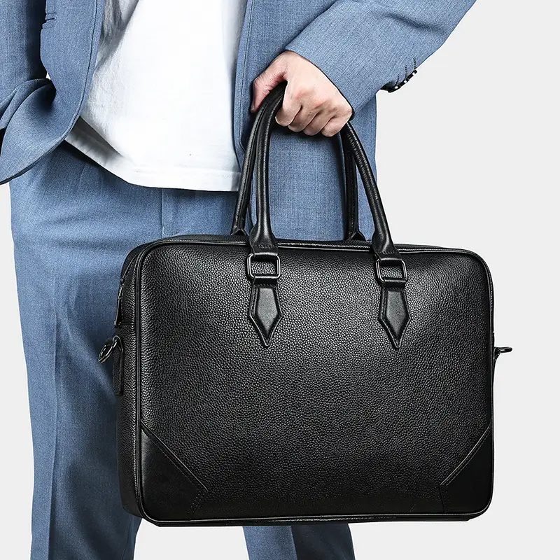 Black leather briefcase held in hand, business style