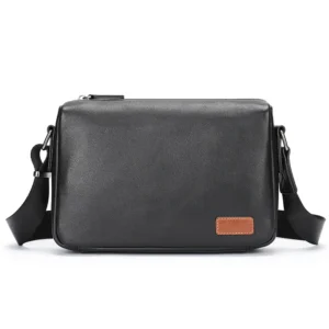 Black leather rectangular crossbody bag, plain background