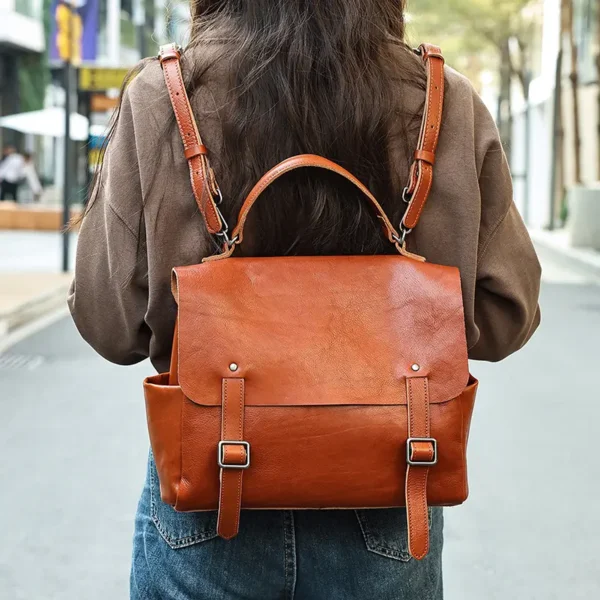 1 (2) Woman carrying brown leather satchel bag, casual street style