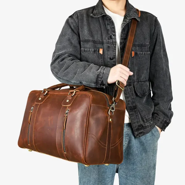 1 (2) Man carrying brown leather duffle bag, casual denim jacket style
