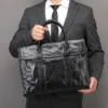 1 (2) Business man holding black leather briefcase, formal suit style