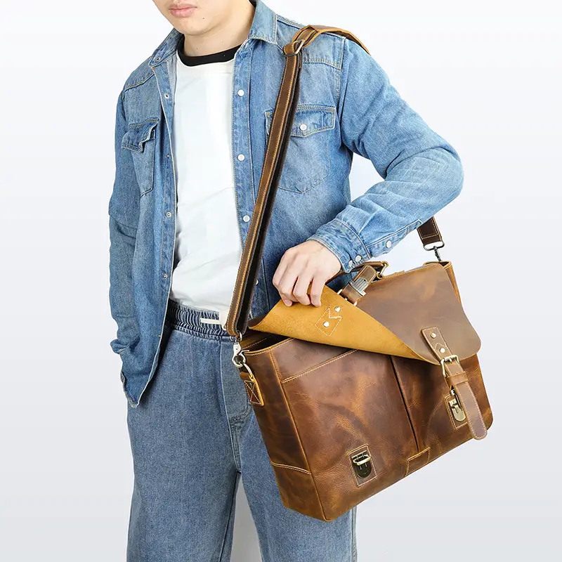 Man carrying brown leather briefcase, casual denim outfit