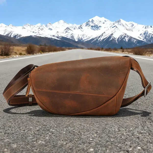1 (26) Brown leather sling bag on mountain background, rustic style
