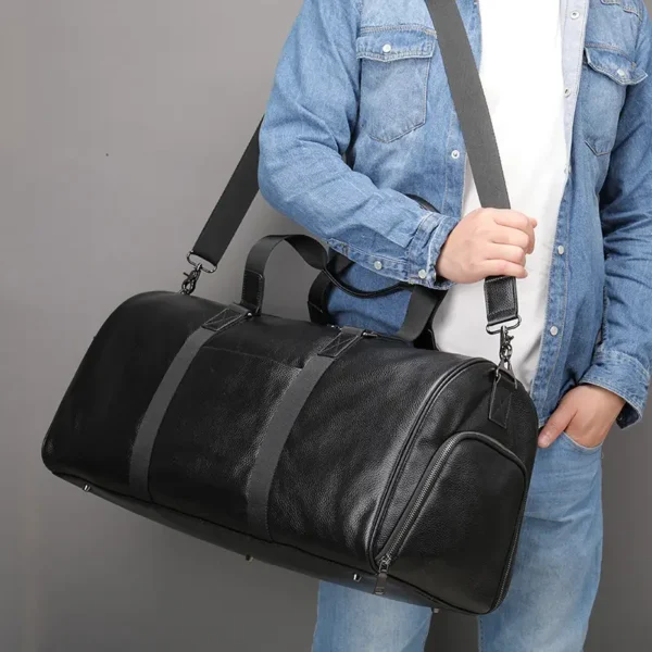 1 (5) Man carrying black leather duffle bag, casual denim style