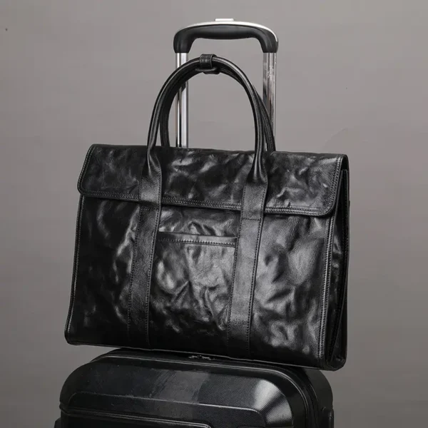 1 (5) Black leather briefcase with trolley sleeve, travel design