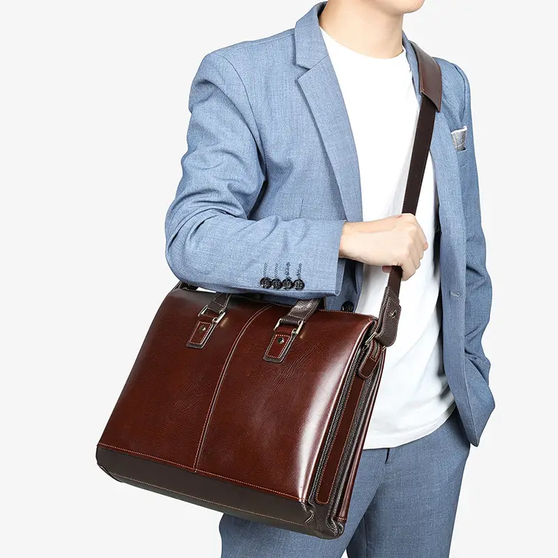 Man carrying brown leather briefcase, business casual outfit
