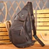 1 (6) Brown leather sling bag on rustic wooden background