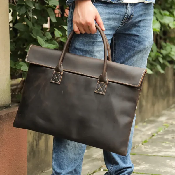 1 (7) Man carrying brown leather tote bag, casual business style