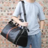 1 (8) Man carrying black leather duffle bag with orange stripe, casual style