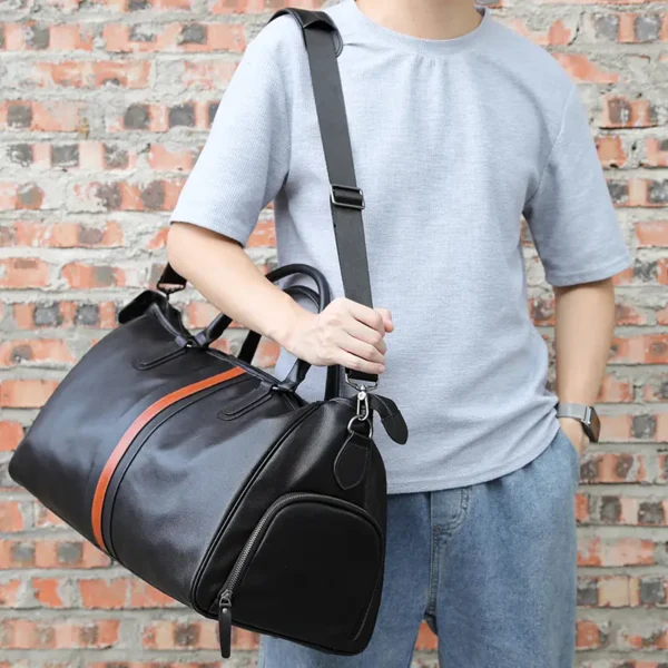 1 (8) Man carrying black leather duffle bag with orange stripe, casual style