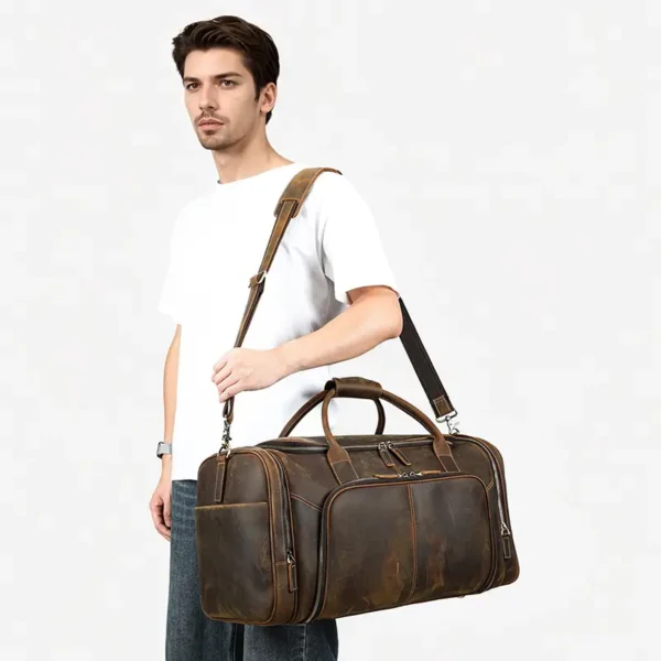 1 (8) Man carrying brown leather duffle bag, casual white t-shirt style