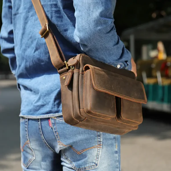 1 (8) Man carrying brown leather crossbody bag, outdoor style