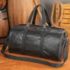 1 (9) Vintage black leather duffle bag with distressed texture, studio shot