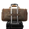 1 (9) Brown leather travel duffle bag with trolley sleeve, studio shot
