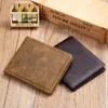 Two brown leather wallets on vintage book background