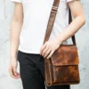 Leather crossbody bag style 7433 carried by hand