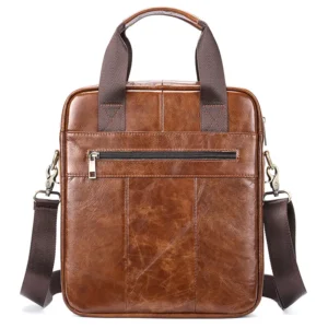 Vintage brown leather vertical tote bag with zipper closure, studio shot