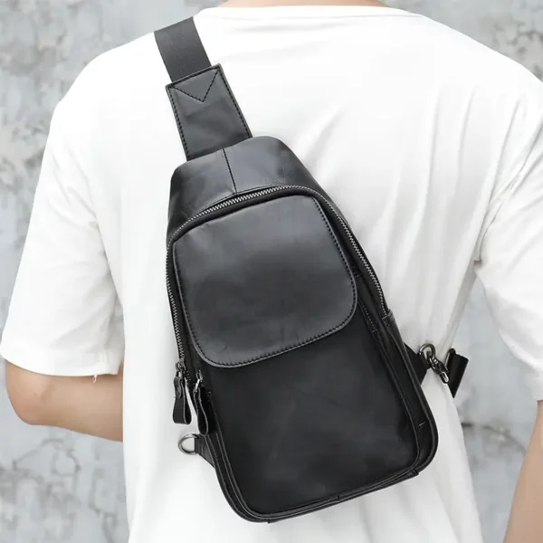 11 Black leather sling backpack, studio shot