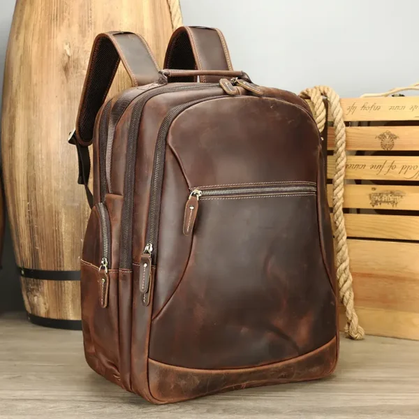 Vintage brown leather backpack on wooden background