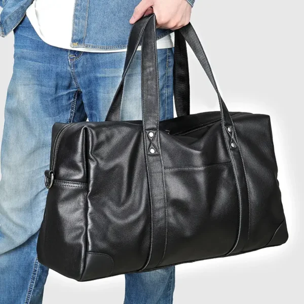 12 Man carrying black leather duffle bag, casual denim style