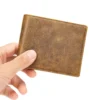 Hand holding a small vintage brown leather bifold wallet