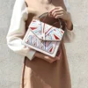 3 Woman carrying patterned leather crossbody bag, casual style