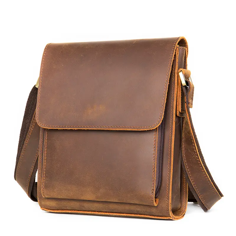 Vintage brown leather messenger bag, studio shot