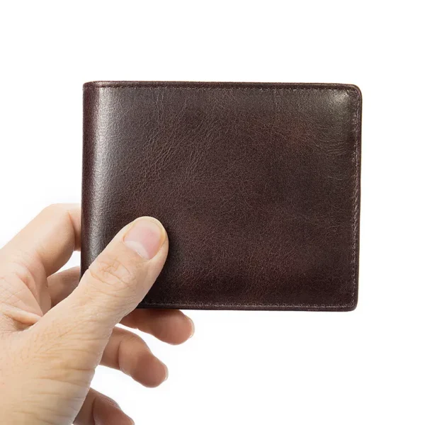 Hand holding a dark brown leather bifold wallet, studio shot