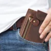 Brown leather zip wallet in jeans pocket, casual daily use