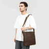 ai Young man carrying brown leather crossbody bag, casual style