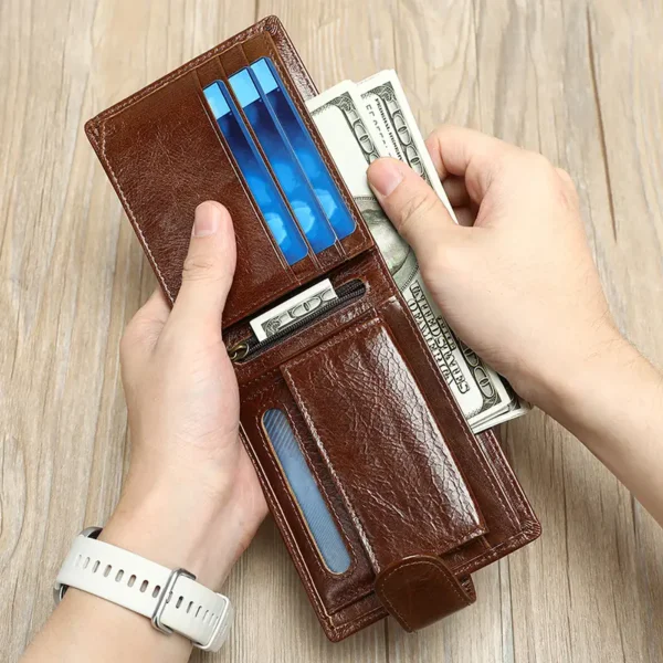 Hand inserting credit card into a brown leather wallet