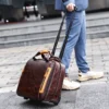 咖啡 (12) Man pulling brown leather duffle bag with trolley sleeve, casual street style