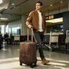 疯马咖-(13) Business man pulling brown leather trolley luggage, airport casual style