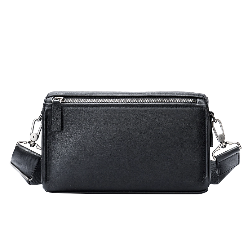 Black leather rectangular crossbody bag with metal accents, studio shot