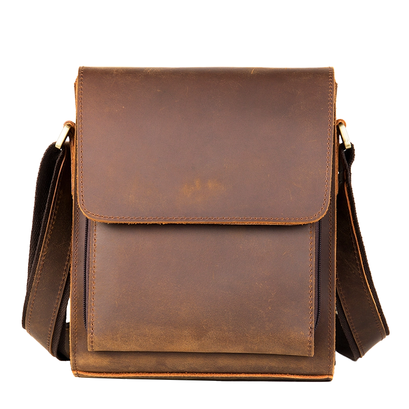 Vintage brown leather messenger bag, plain studio background