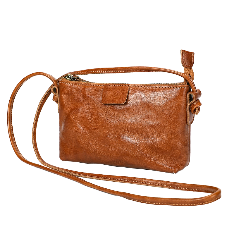 Vintage brown leather crossbody bag, plain studio shot