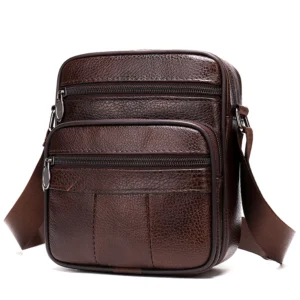 Vintage brown leather crossbody bag with multiple pockets, studio shot