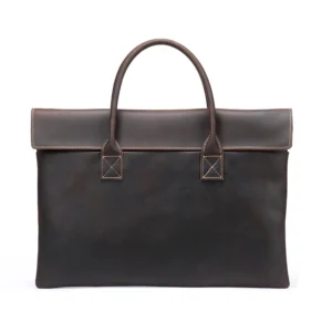 Brown leather messenger bag on rustic wooden background