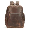 Brown leather backpack with multiple compartments, plain background