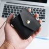 black Crazy Horse leather earphone pouch PL-109 shown in hand
