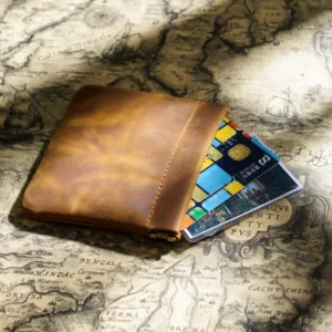 brown Crazy Horse leather squeeze pouch holding bank cards