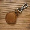 Brown Crazy Horse leather AirTag holder with metal snap hook detail