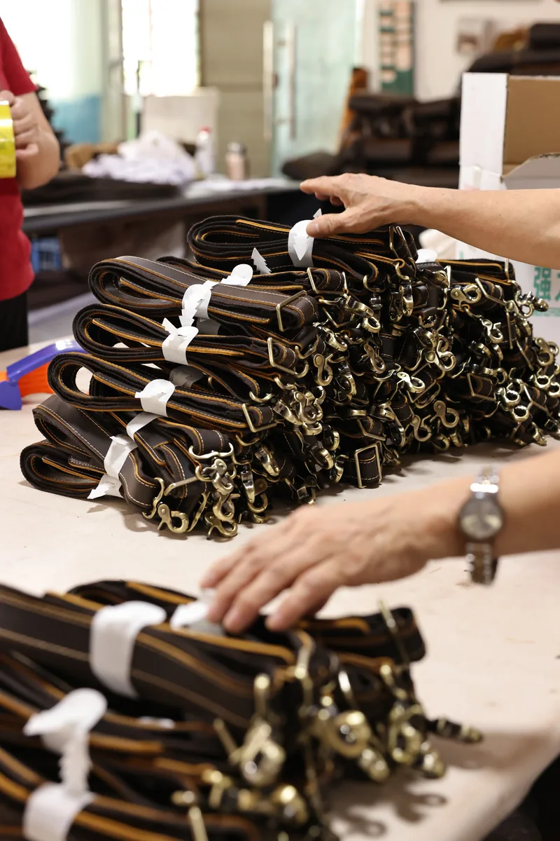 Batch of finished leather bag straps with metal hardware