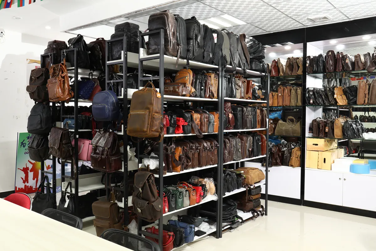 Leather backpacks, briefcases and shoulder bags displayed on showroom shelves