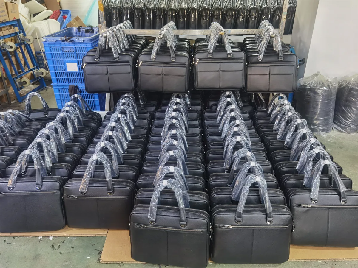Rows of black leather briefcases with protective wrapping around their handles