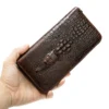 coffee crocodile pattern leather clutch wallet held in hand