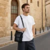 Black cowhide crossbody bag style 6536 worn over the shoulder