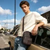 coffee crossbody leather bag style D6293 worn by a man